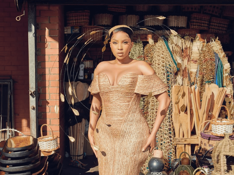 Linda Mtoba wearing a gold dress