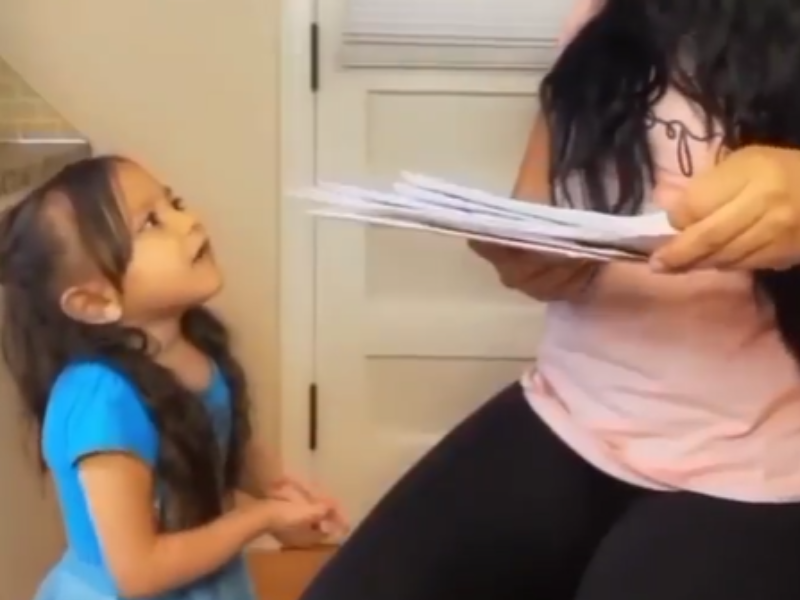 Little girl speaking to an adult