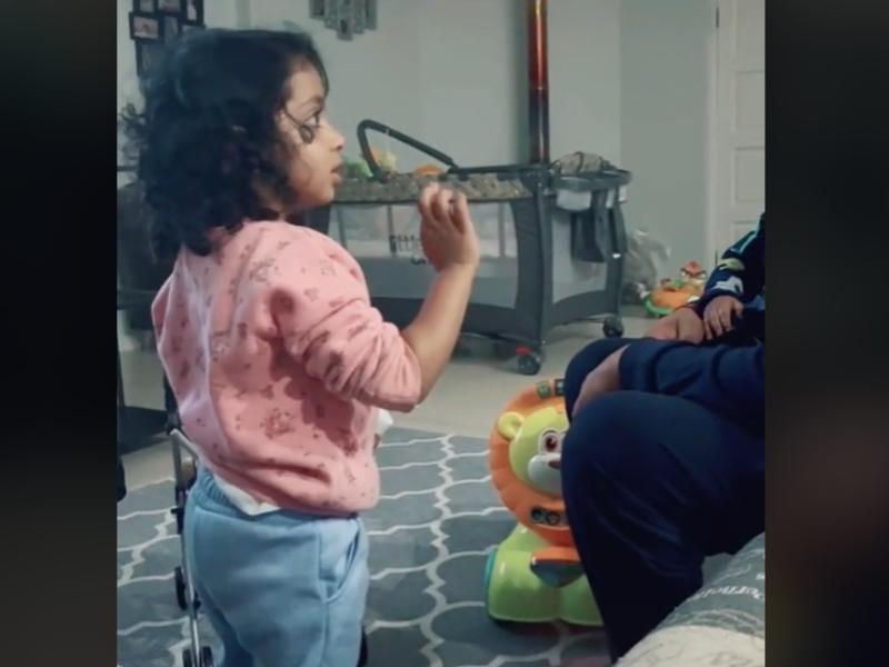 Little girl talks to her father confidently