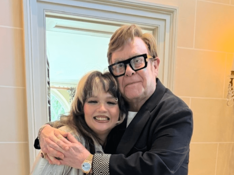 Lola Young and Elton John hugging