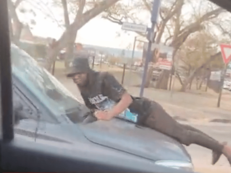 MAN HANGING ON CARS BONNET MBOMBELA