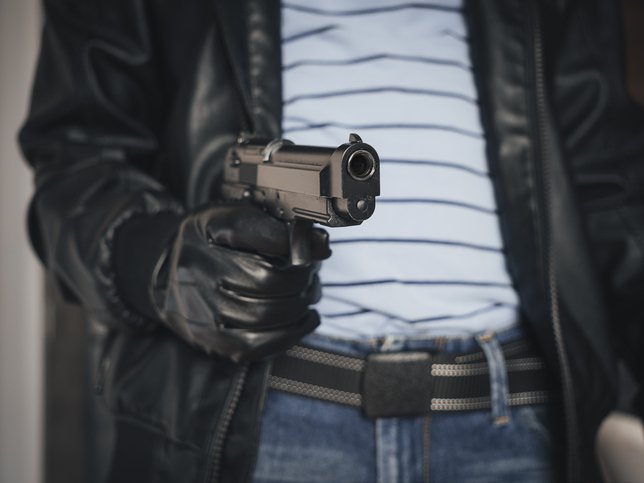 MAN HOLDING GUN IN ROBBERY