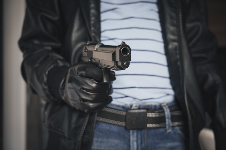 MAN HOLDING GUN IN ROBBERY