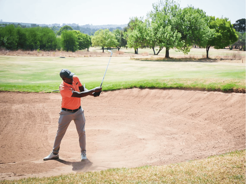 MAN PLAYING GOLF JACARANDA FM GOLF DAY