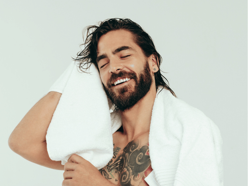 MAN WITH BEARD DRYING HIMSELF