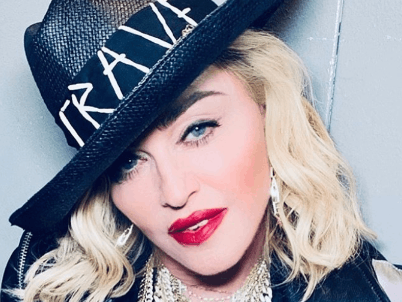 Madonna wearing a black crave hat