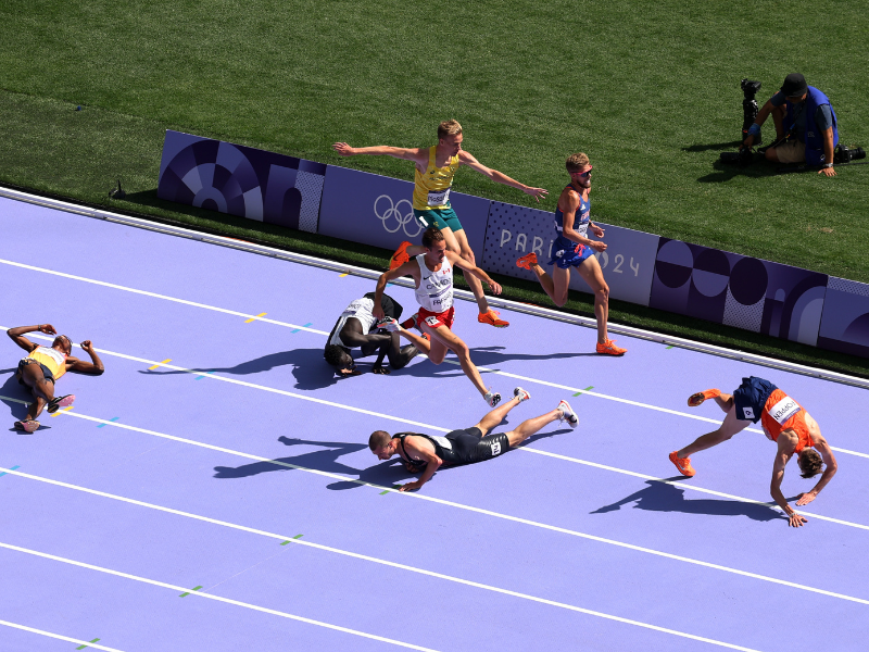Male athletes fall to the ground at the men's heats at Paris Olympics