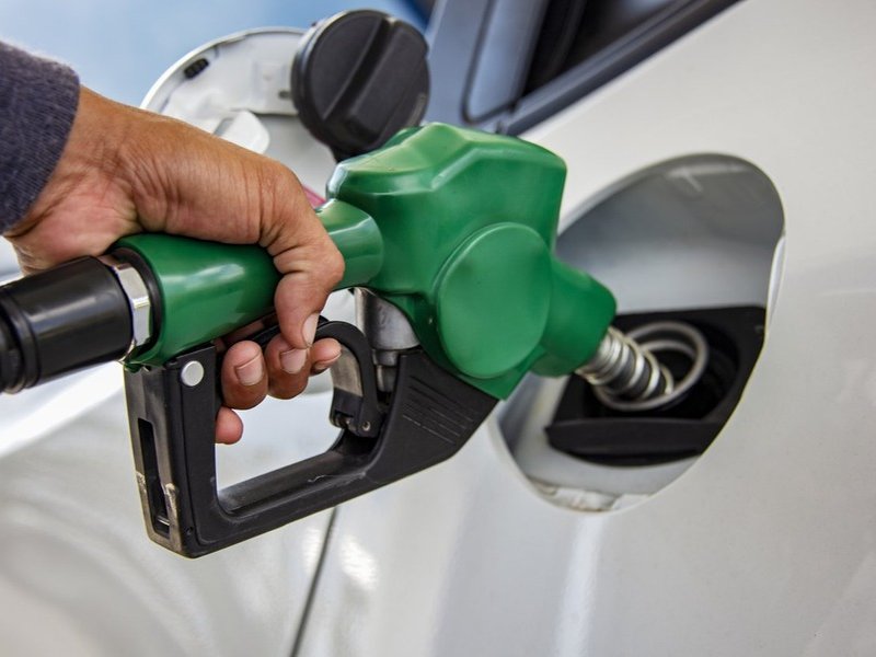 Man Handle pumping gasoline fuel nozzle to refuel