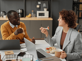 Man and woman having lunch together at work