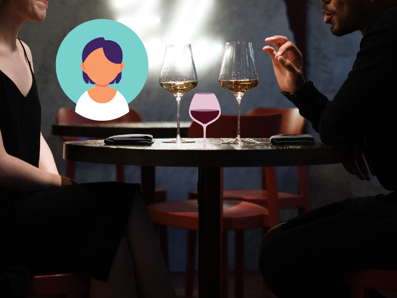 Man and woman sitting at a table drinking wine