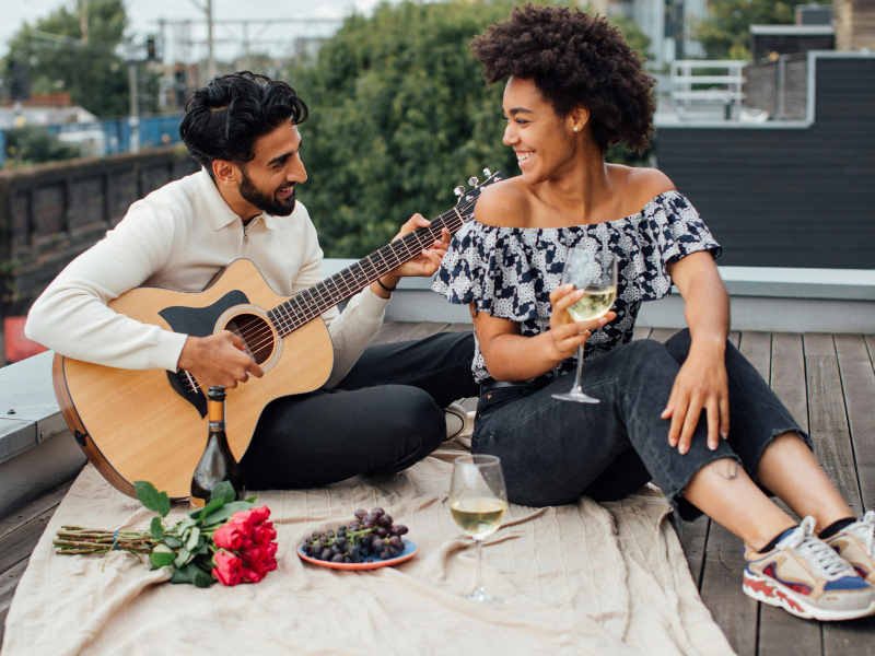 Man and woman sitting on a rooftop on a date