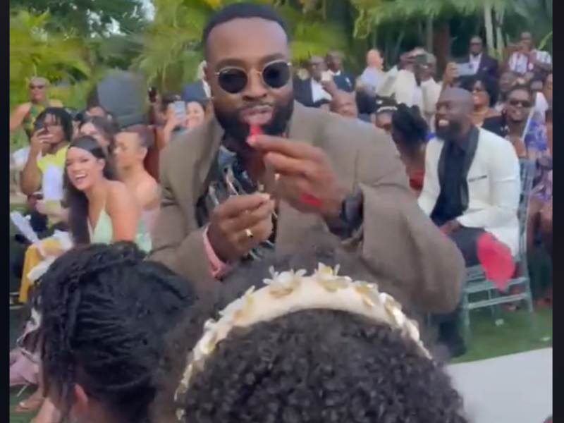 Man blowing flower petals at a wedding