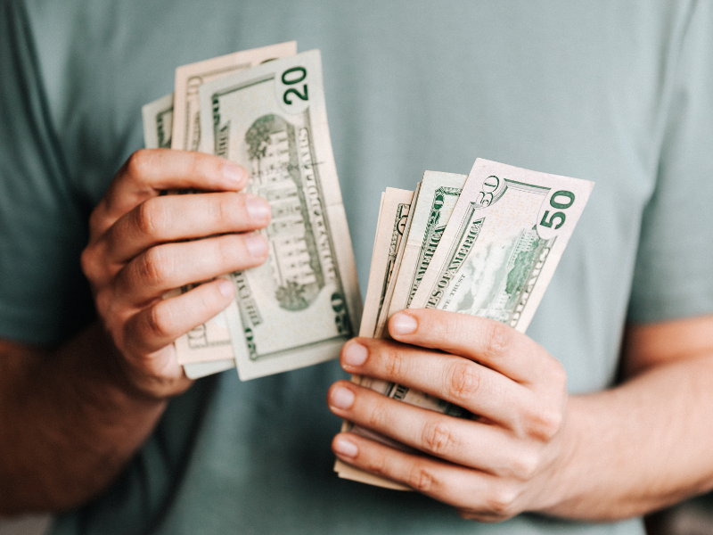 Man counting dollar banknotes
