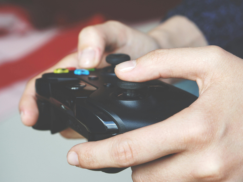 Man holding a black game controller