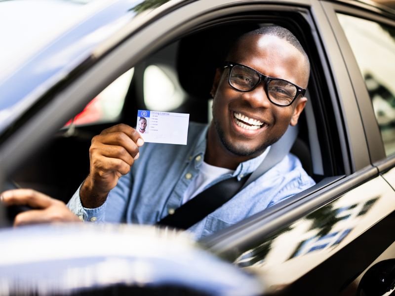 Man holding driving licence card