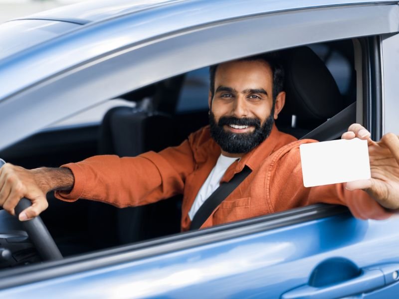 Man holding driving licence card