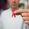 Man holding red ribbon