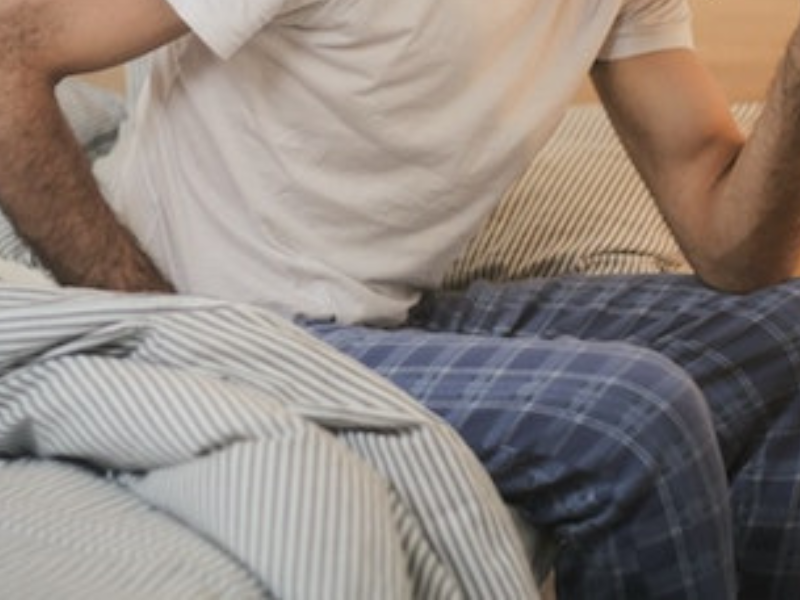 Man in sleepwear suffering from a headache