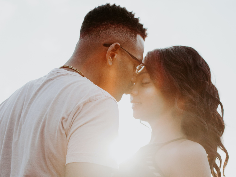 Man kissing a woman on her nose