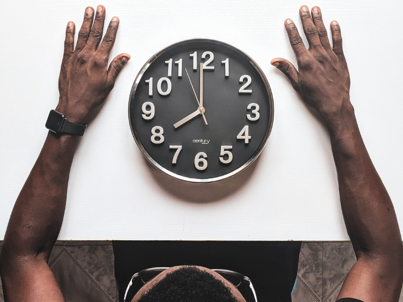 Man looking at the clock on the table