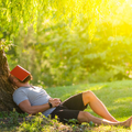 Man lying under tree