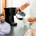 Man pouring a cup of coffee in the morning