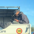 Man reading Bible on back of truck