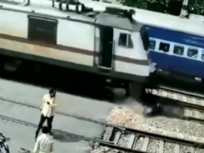 Man running away from train travelling past him