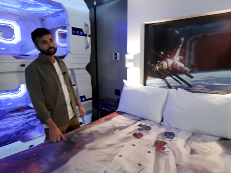 Man standing in the space themed room at Fantasyland