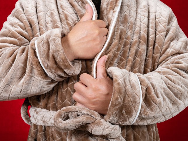 Man tightening up a domestic fluffy winter gown