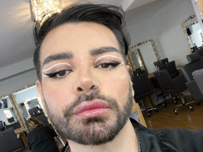Man wearing makeup with beard and nosering