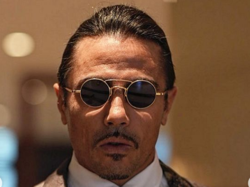 Man wearing sunglasses and a fancy coat