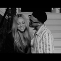 Mariah Carey and Anderson .Paak at the bottom of a staircase