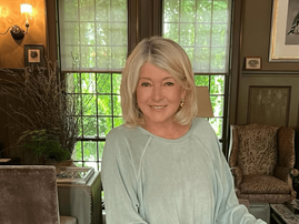 Martha Stewart poses in a room with vintage style decor