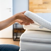 Mattress Topper Being Laid On Top