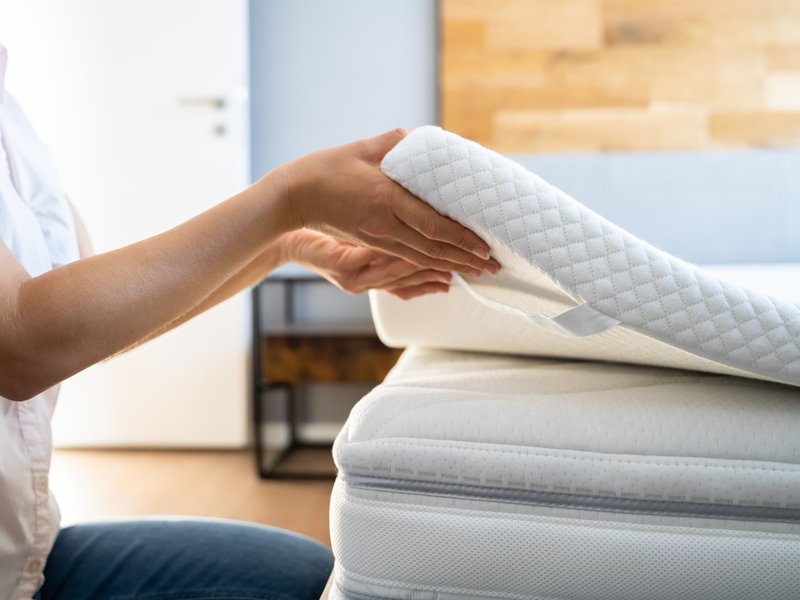 Mattress Topper Being Laid On Top
