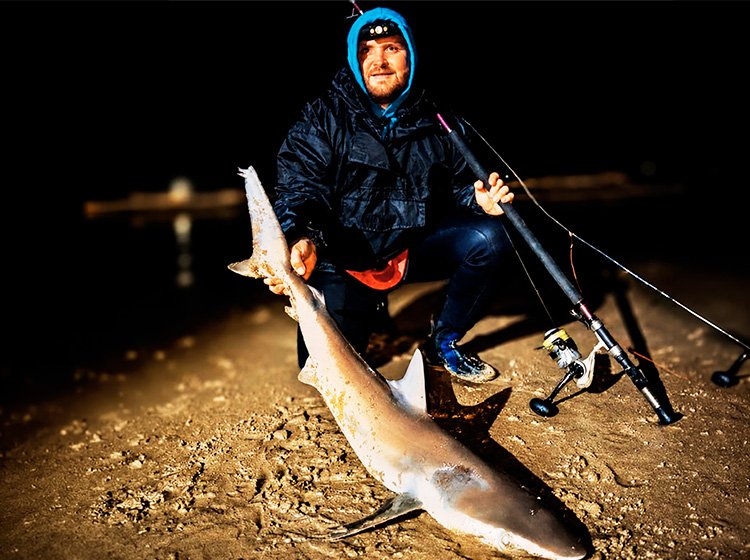 Max Stamatis with a grey shark in tough conditions at Scottburgh