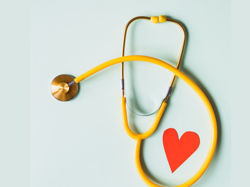 Medical stethoscope with red paper heart