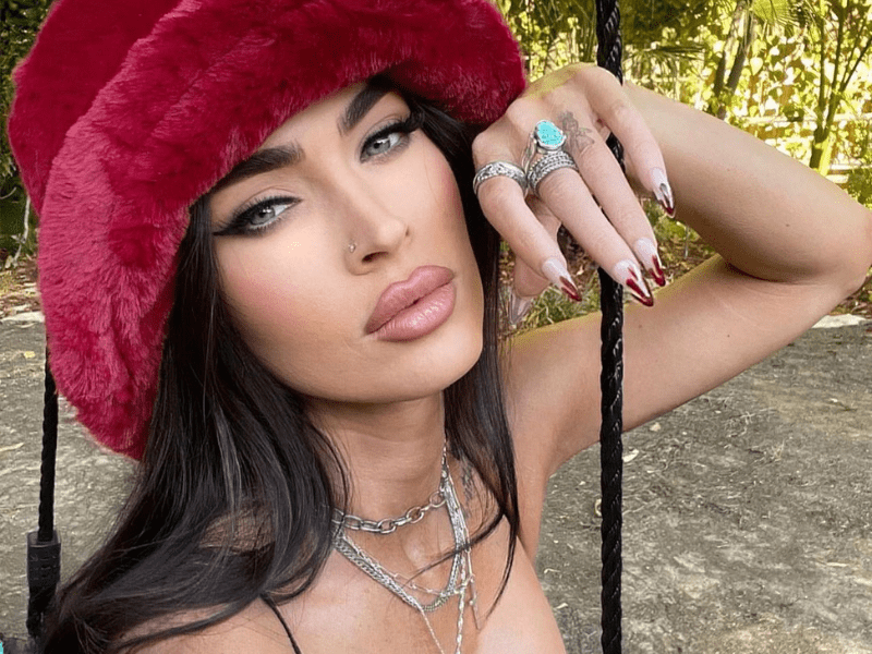 Megan Fox wearing a red fur har