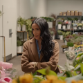 Meghan Markle surrounded by flowers in a florist shop
