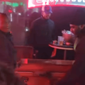 Men carry a casket into a nightclub