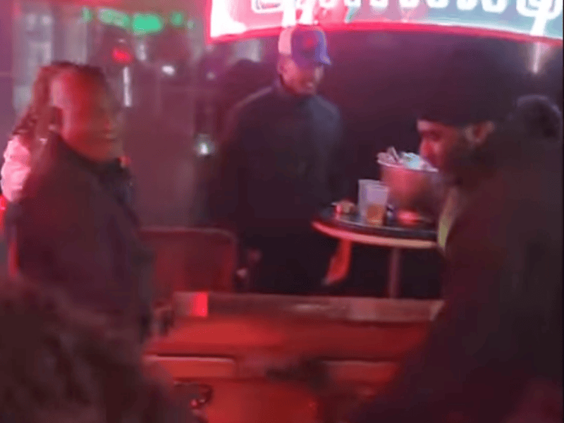 Men carry a casket into a nightclub