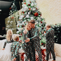 Michael Bublé and his family decorating a Christmas tree