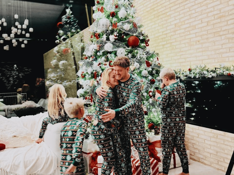 Michael Bublé and his family decorating a Christmas tree
