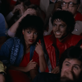 Michael Jackson and Ola Ray sitting in a movie theatre