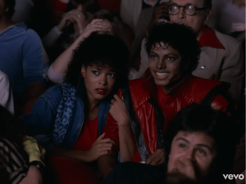 Michael Jackson and Ola Ray sitting in a movie theatre