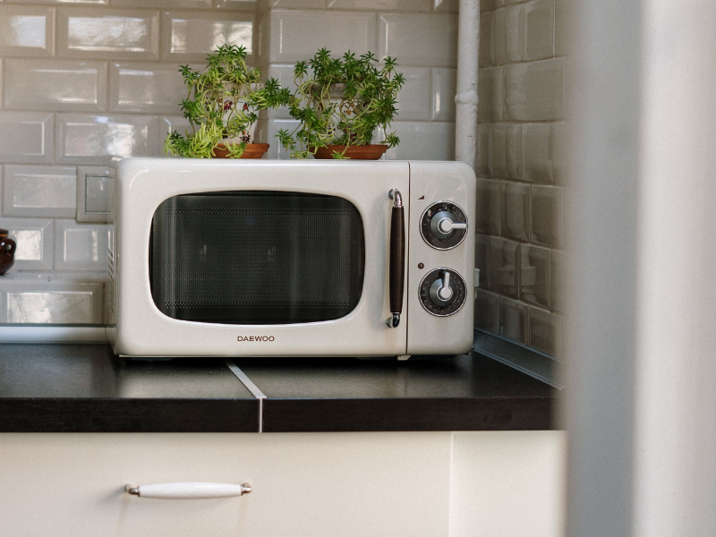 Microwave oven on white wooden cabinet