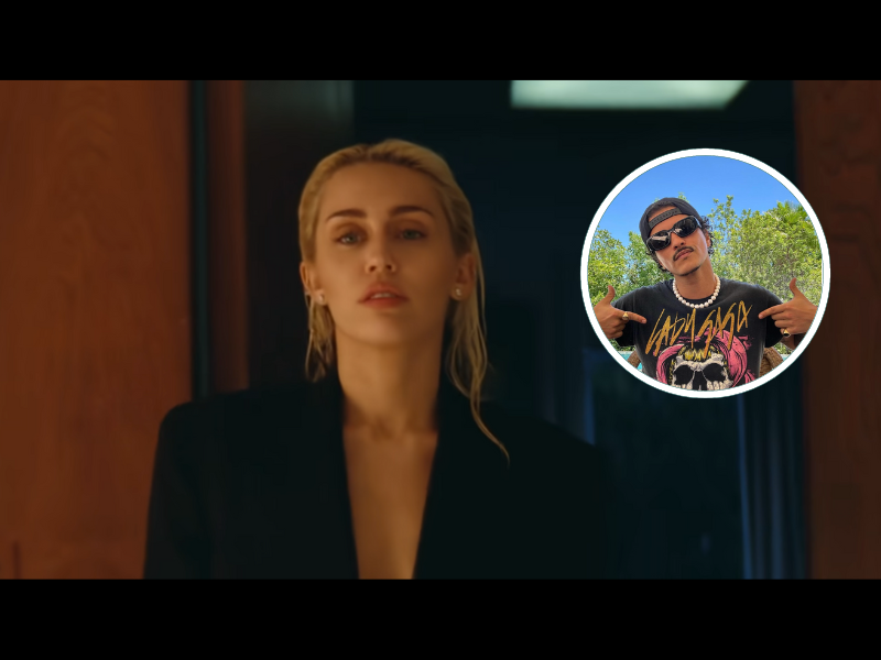 Miley Cyrus wearing a men's black suit jacket and her blonde hair slicked black.png