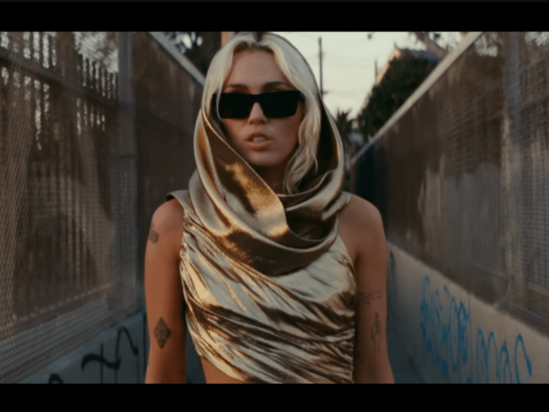 Miley Cyrus wears Yves Saint Laurent with dramatic cowl-style neckline