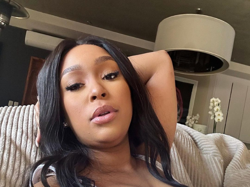 Minnie Dlamini takes a selfie on a couch